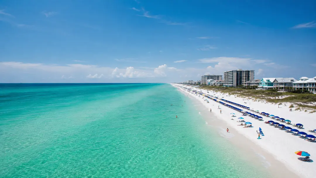 The Gulf shoreline at Destin, lined with beach umbrellas.
